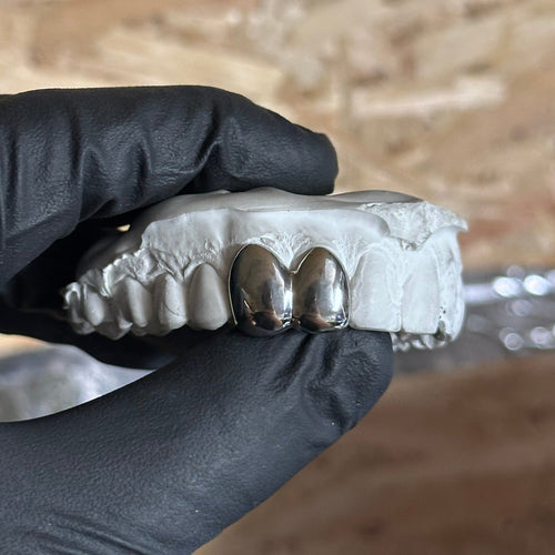 2 solid dental silver caps joined 