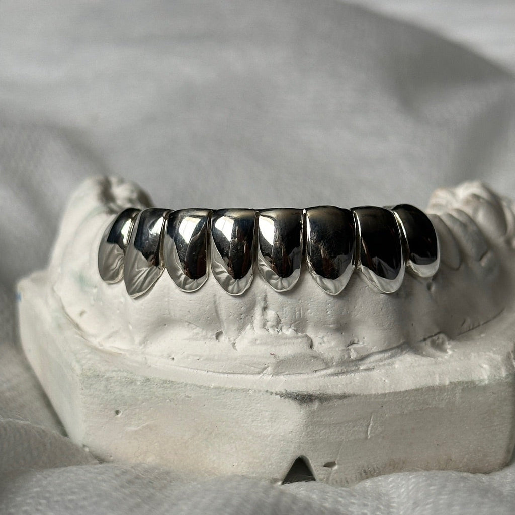 dental silver grillz 8 set on a white stone model