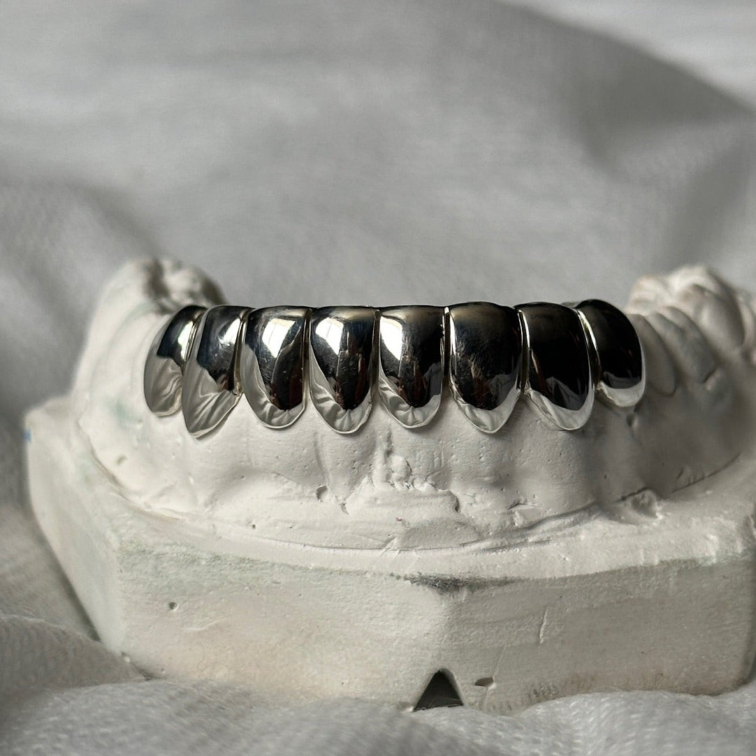 dental silver grillz 8 set on a white stone model