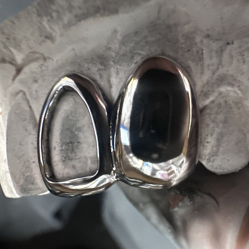 Solid and Window dental silver grillz on stone model